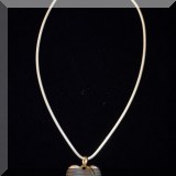 J02. Sterling silver and gold heart necklace. 